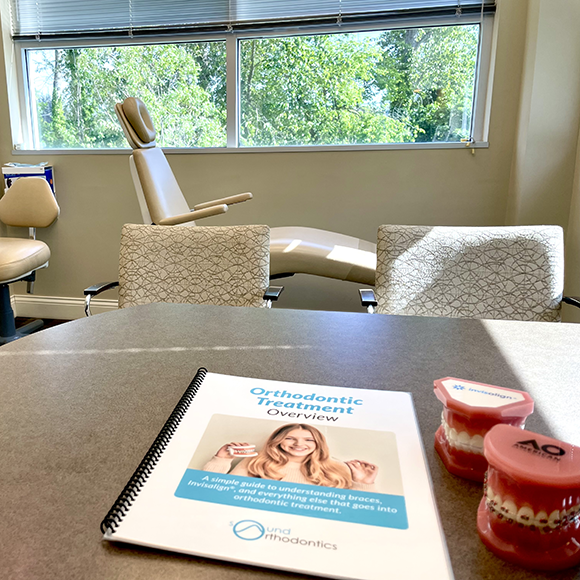 Interior office, orthodontic treatment overview booklet sitting on table.